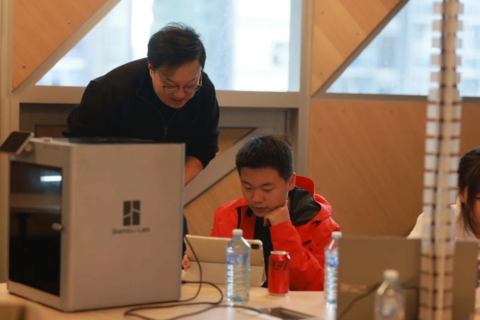 A student working with a desktop 3D printer during the workshop